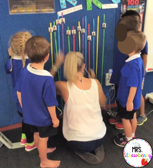 students and teacher creating a height wall