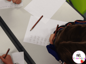 kids writing their name 100 times on the 100th day of school