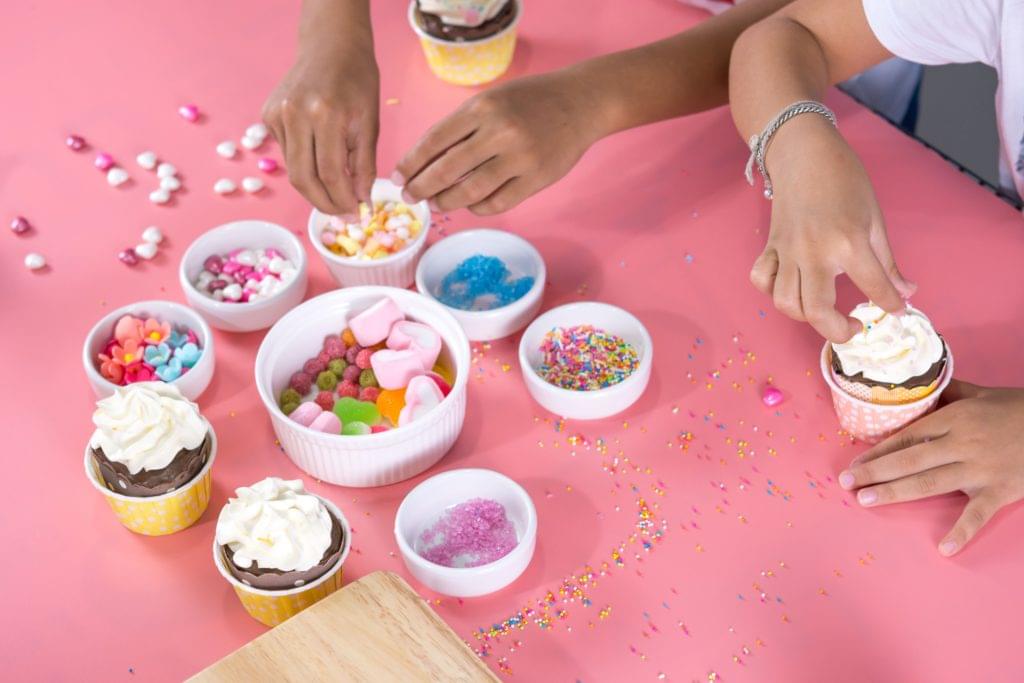 children decorating cup cakes for Mother's Day pampering session